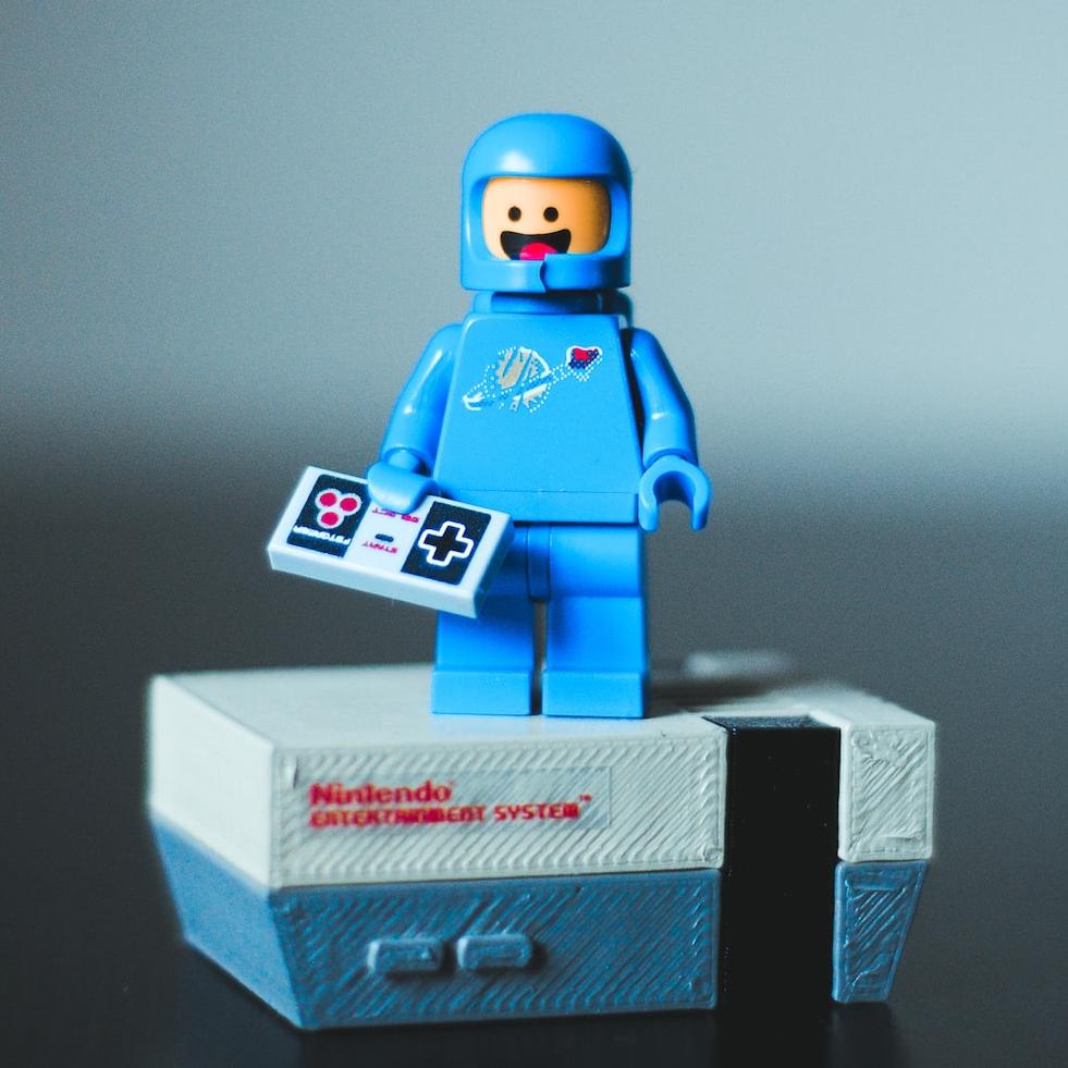 selective focus photography of blue LEGO minifigure